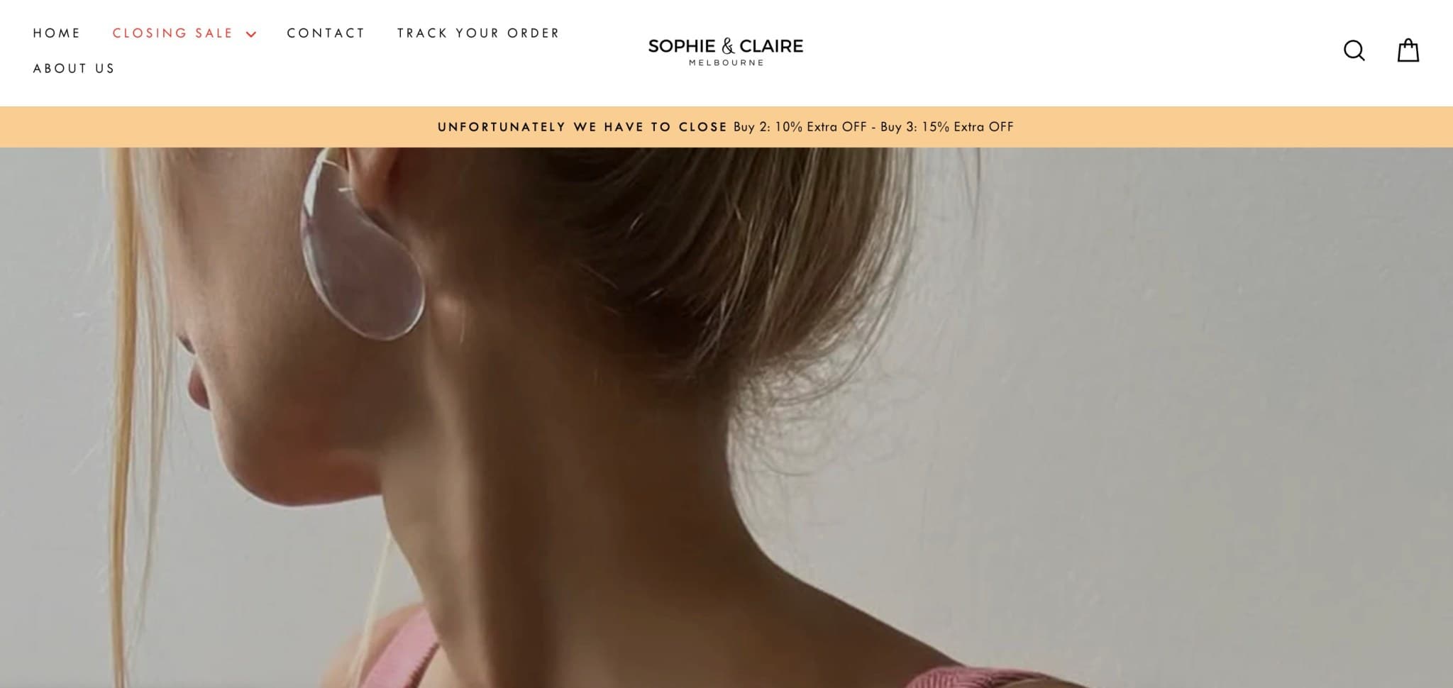 an advertisement for the store 'sophie and claire', featuring the neck of a woman with her hair in a bun